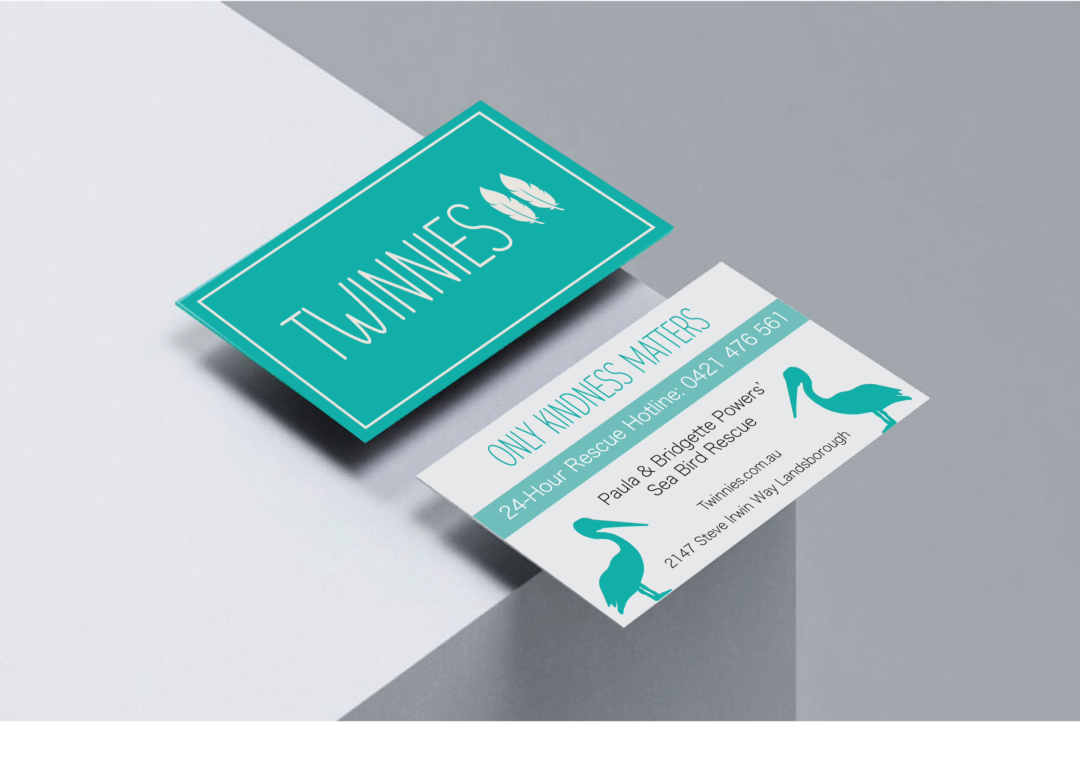 Business card with pelican feather logo.